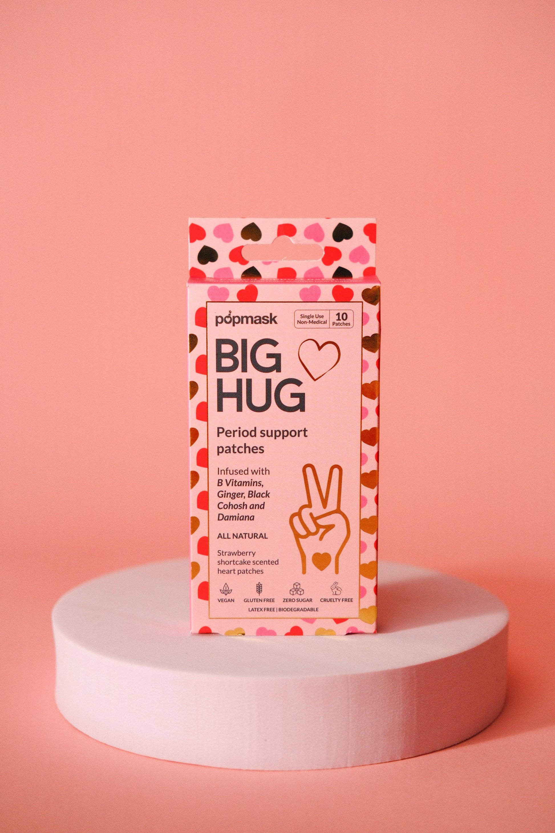 Package of 'Big Hug' period support patches on a pink platform with a pink background