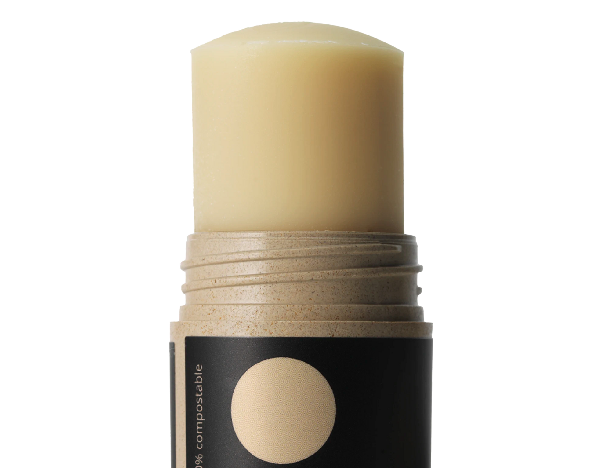 Beige stick of foundation with a black label on a white background