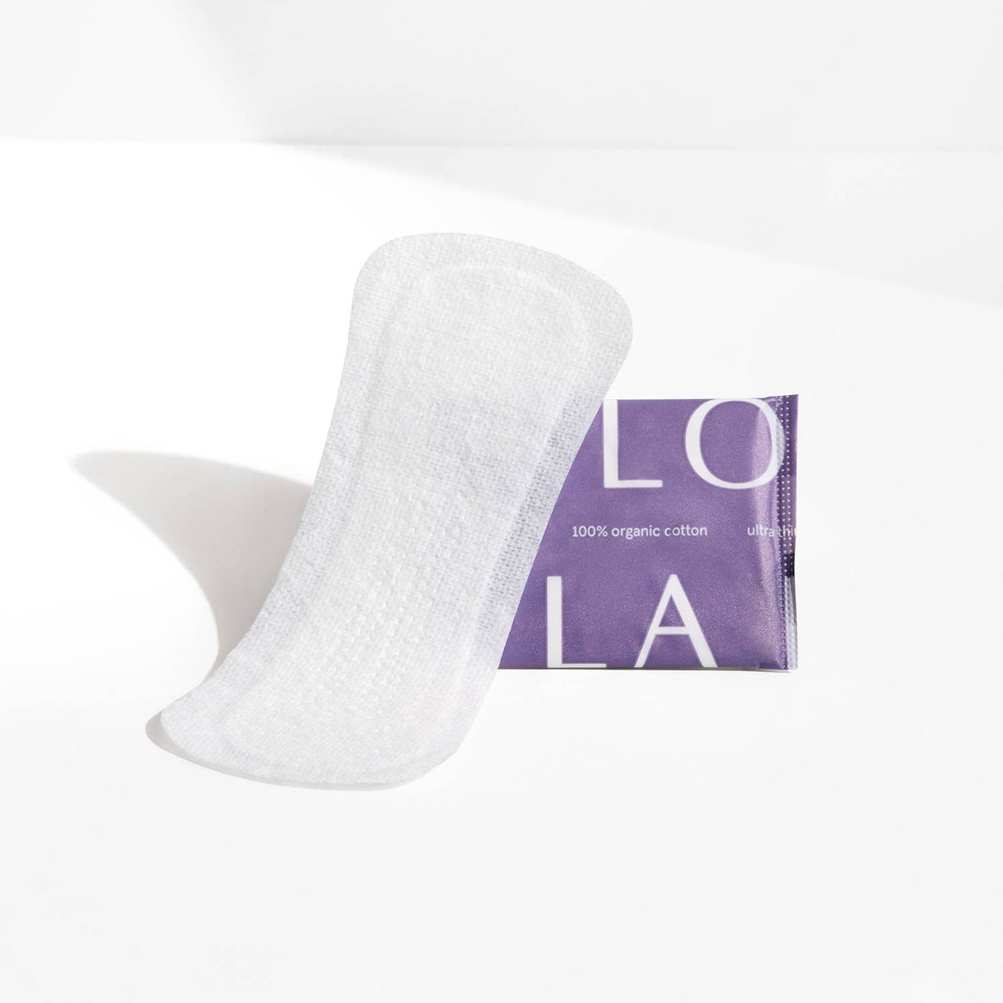 White organic cotton Lola pad with a purple label on a white background
