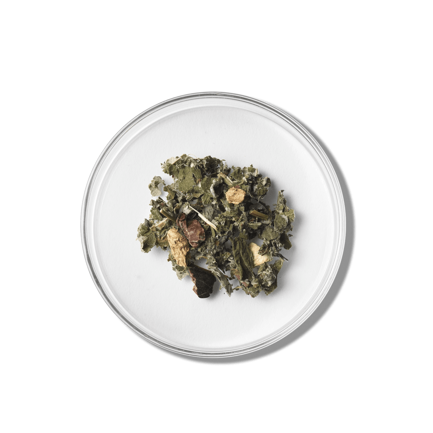 Raspberry Leaf Herbal tea leaves on a white plate with a green background